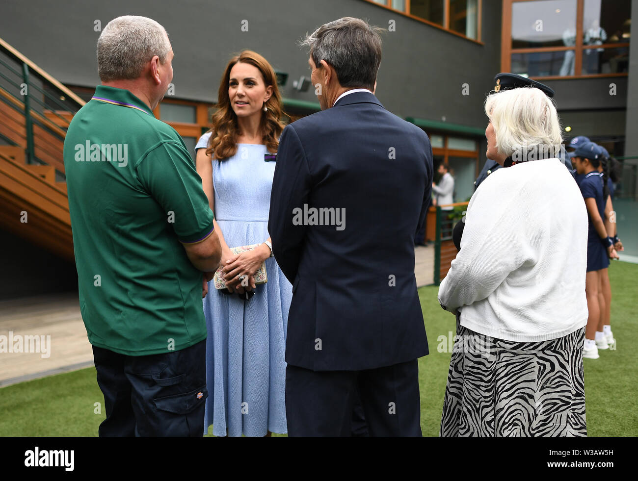 The Duke and Duchess of Cambridge meet (left to right) Mick Woods, from the AELTC facilities management department, referee Andrew Jarrett and Jayne Miller, AELTC ladies dressing room manager, ahead of the Men's Singles Final on day thirteen of the Wimbledon Championships at the All England Lawn Tennis and Croquet Club, Wimbledon. Stock Photo