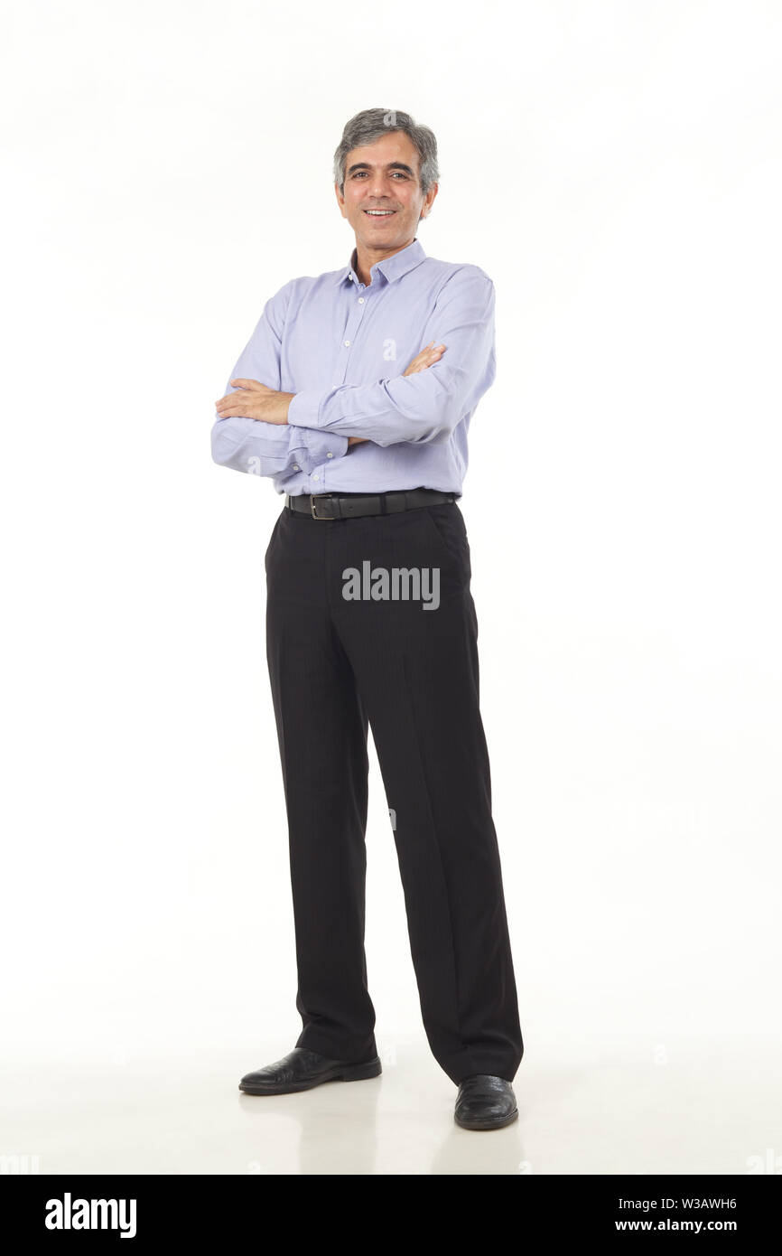 Portrait of a businessman standing with his arms crossed Stock Photo ...