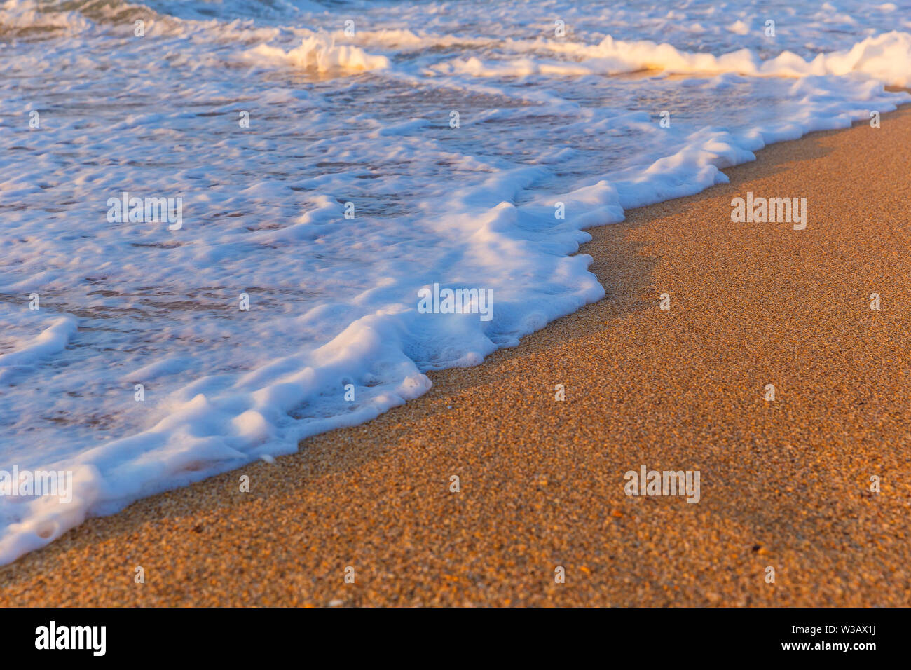 Foam from the sea water on the coast of the beach at sunset day Stock ...