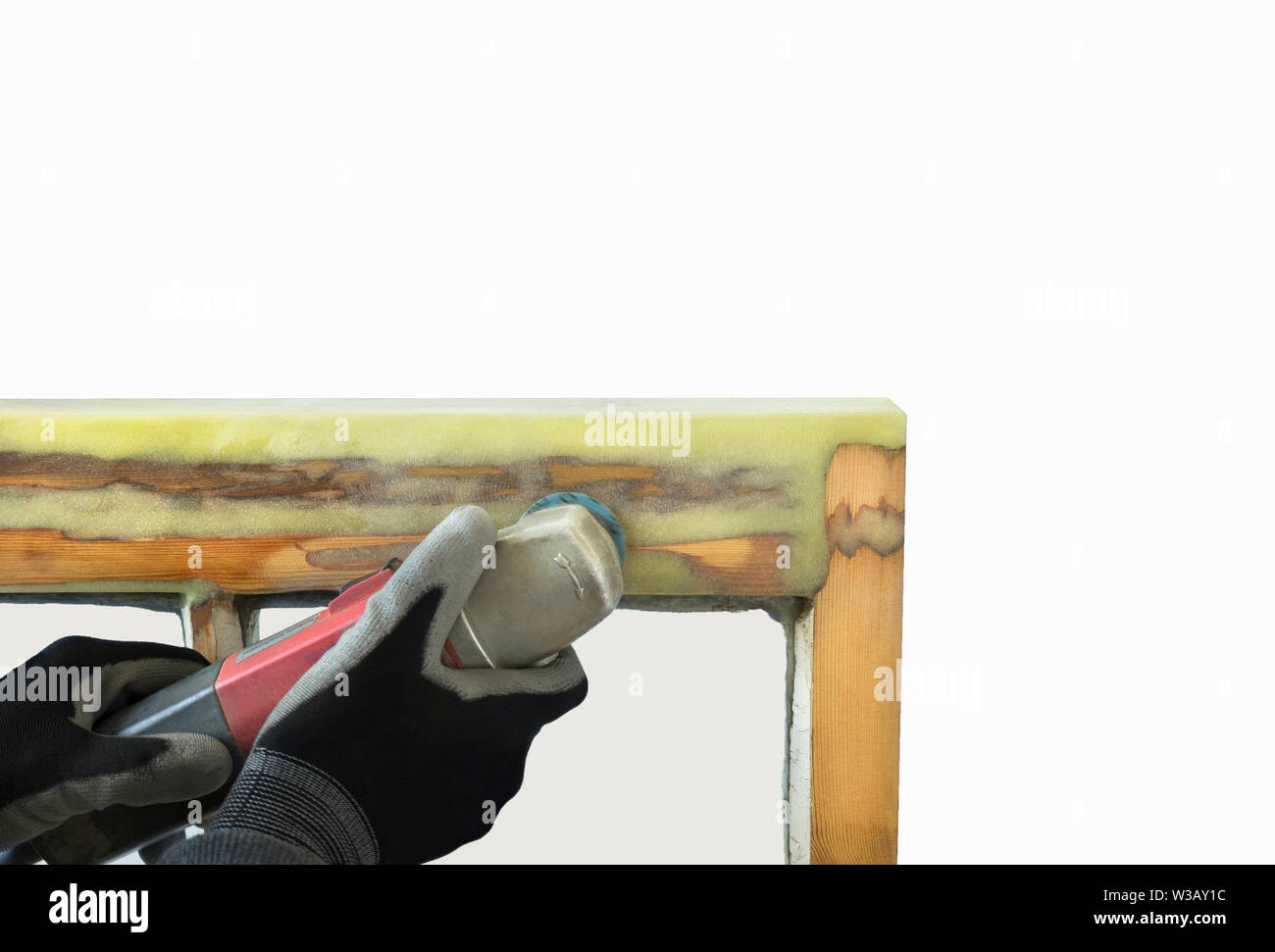 Close up of a person sanding resin of restored sash windows. Sash window restoration Stock Photo