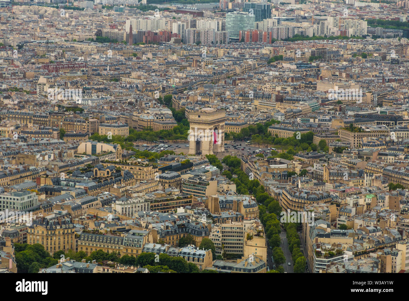 Lovely aerial view of the Arc de Triomphe de l'Étoile and the cityscape of Paris. Streets are leading to the roundabout of which the monument is the... Stock Photo