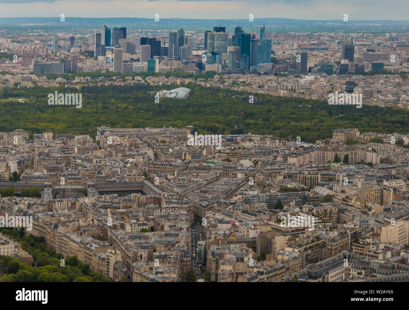 Unique aerial cityscape panorama of the western edge of the 16th arrondissement of Paris. The Bois de Boulogne, a large public park & the skyline of L Stock Photo