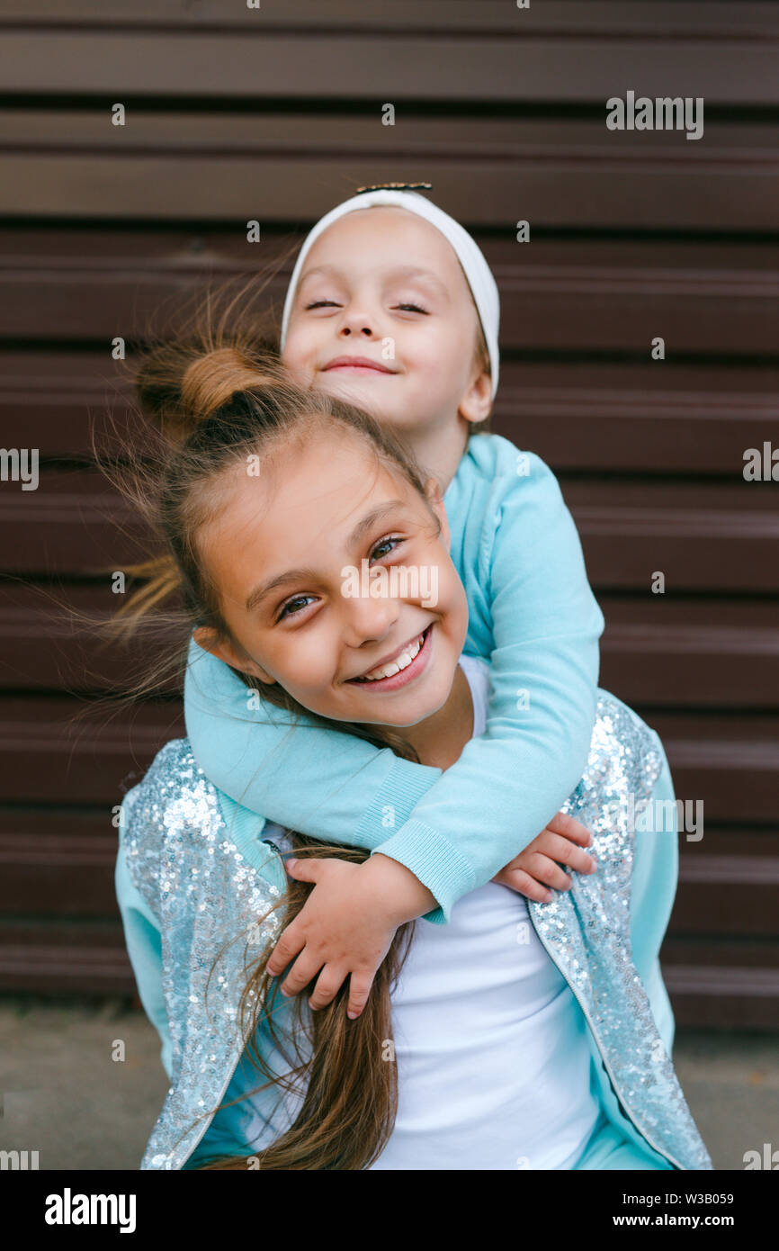 Two little child girls hugging each other with love outdoor Stock Photo ...