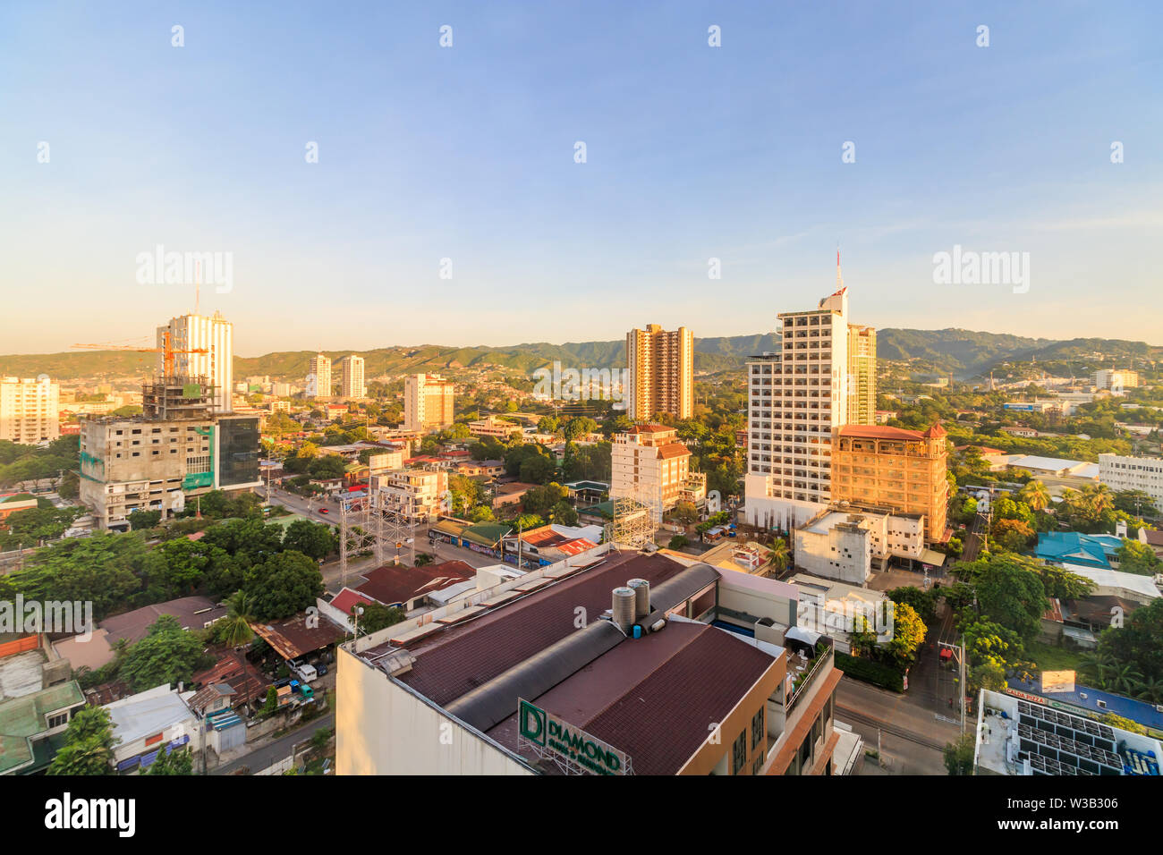 View Of Buildings In Cebu City During Sunrise Stock Photo