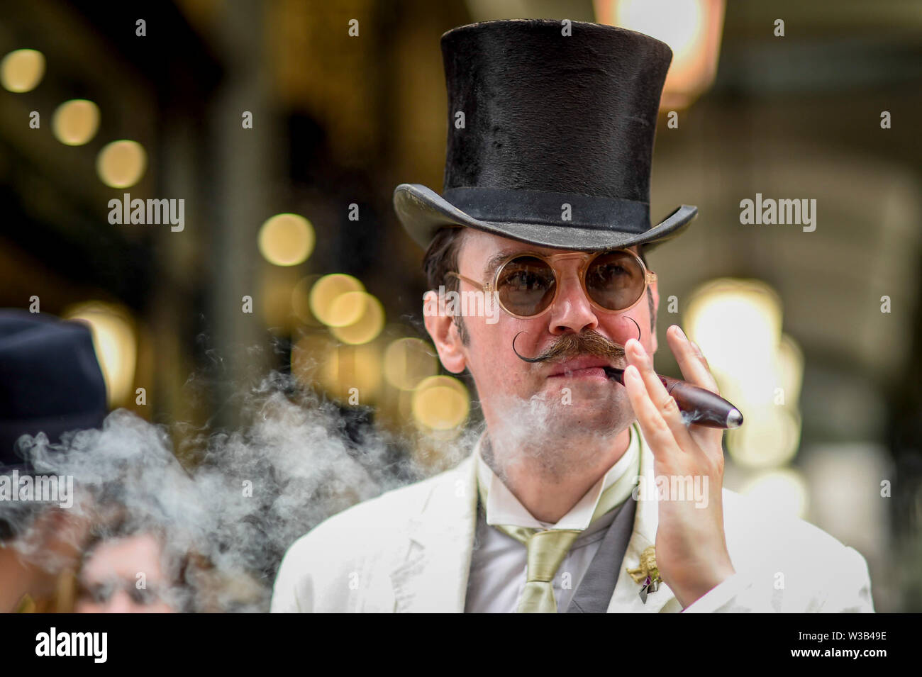 London, UK. 14 July 2019.   An elegantly dressed man takes part in The Grand Flâneur walk.  Starting at the Beau Brummell statue on Jermyn Street, the walk coincides with the 20th anniversary of The Chap magazine and is defined as a walk without purpose, celebrating the art of the flâneur, oblivious to going anywhere specific, and an antidote to the demands of modern life and the digital smartphone.  Similar walks are taking place in Dusseldorf and Los Angeles. Credit: Stephen Chung / Alamy Live News Stock Photo