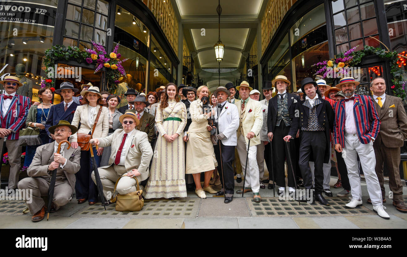 London, UK. 14 July 2019.   Elegantly dressed people take part in The Grand Flâneur walk.  Starting at the Beau Brummell statue on Jermyn Street, the walk coincides with the 20th anniversary of The Chap magazine and is defined as a walk without purpose, celebrating the art of the flâneur, oblivious to going anywhere specific, and an antidote to the demands of modern life and the digital smartphone.  Similar walks are taking place in Dusseldorf and Los Angeles. Credit: Stephen Chung / Alamy Live News Stock Photo