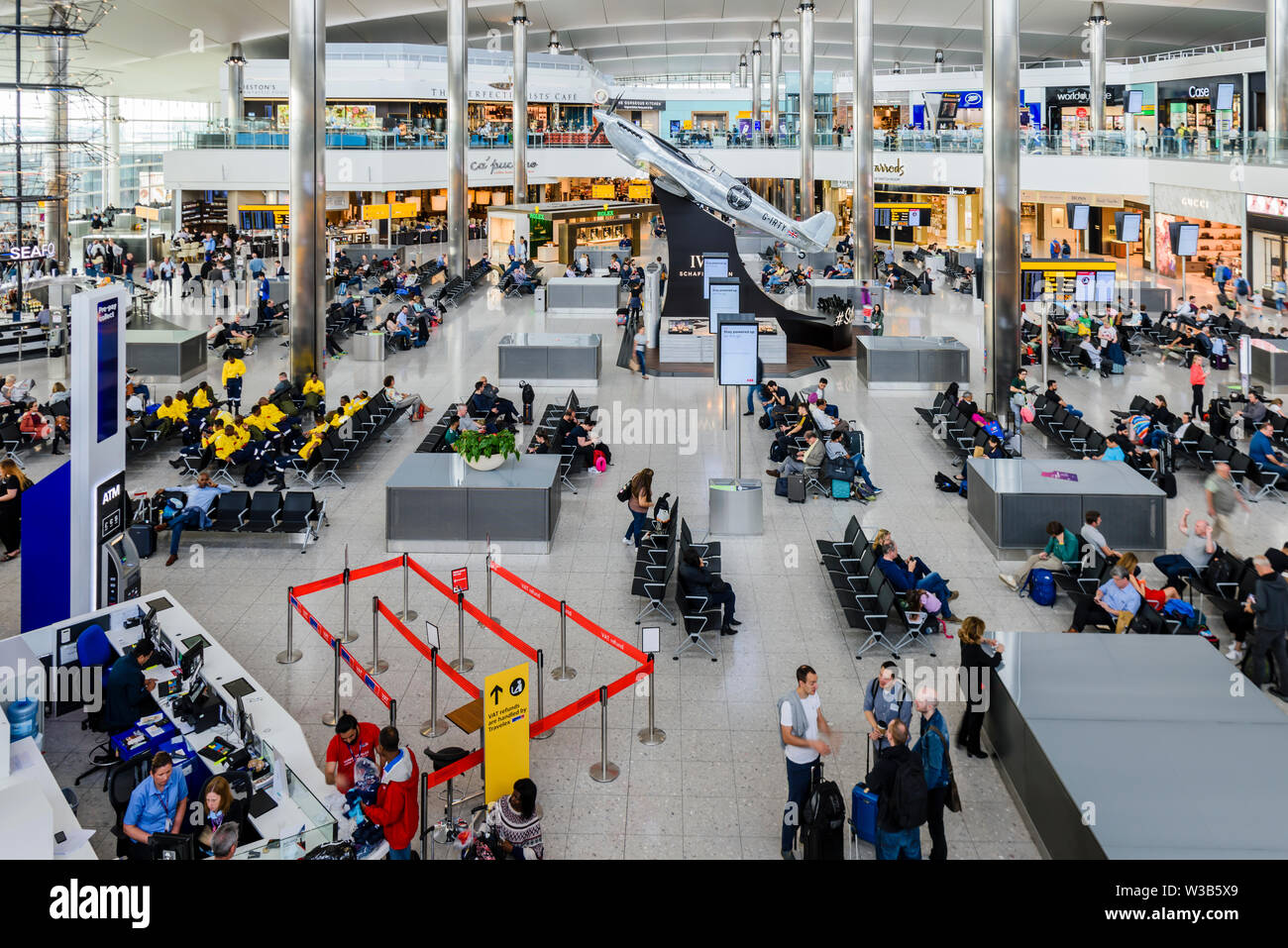 Passengers waiting for flights at Terminal 3, Heathrow Airport, London, England, United Kingdom, UK Stock Photo