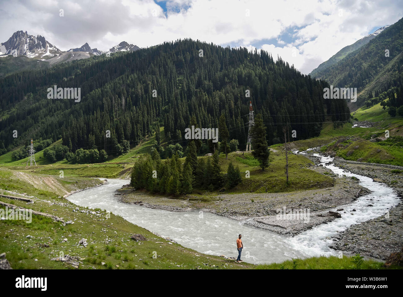 Ganderbal, Jammu and Kashmir, India. 13th July, 2019. River Sindh flowers under the foothill of Himalayan mountains during a cloudy evening in Sonamarg, some 85kms from summer capital Srinagar.Jammu and Kashmir is a disputed territory divided between India and Pakistan but claimed in its entirety by both sides. Credit: Idrees Abbas/SOPA Images/ZUMA Wire/Alamy Live News Stock Photo