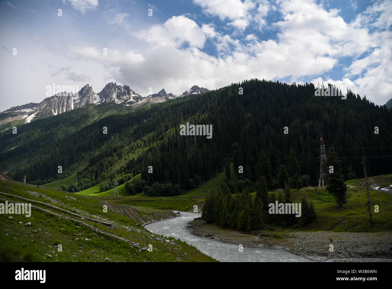 Ganderbal, Jammu and Kashmir, India. 13th July, 2019. River Sindh flowers under the foothill of Himalayan mountains during a cloudy evening in Sonamarg, some 85kms from summer capital Srinagar.Jammu and Kashmir is a disputed territory divided between India and Pakistan but claimed in its entirety by both sides. Credit: Idrees Abbas/SOPA Images/ZUMA Wire/Alamy Live News Stock Photo