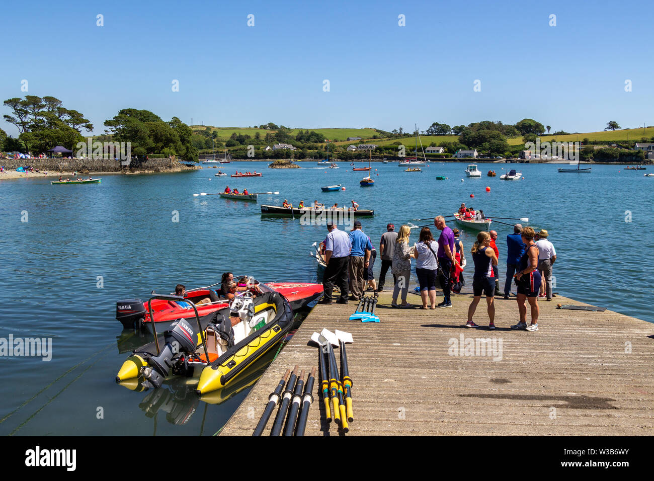 Castletownshend, West Cork, Ireland. 14th July 2019. With the sun shining in a clear blue sky and temperatures up to 24 Deg, with a slight breeze it was a perfect day for the inshore rowing regatta in Castlehaven Harbour. Credit aphperspective/ Alamy Live News Stock Photo