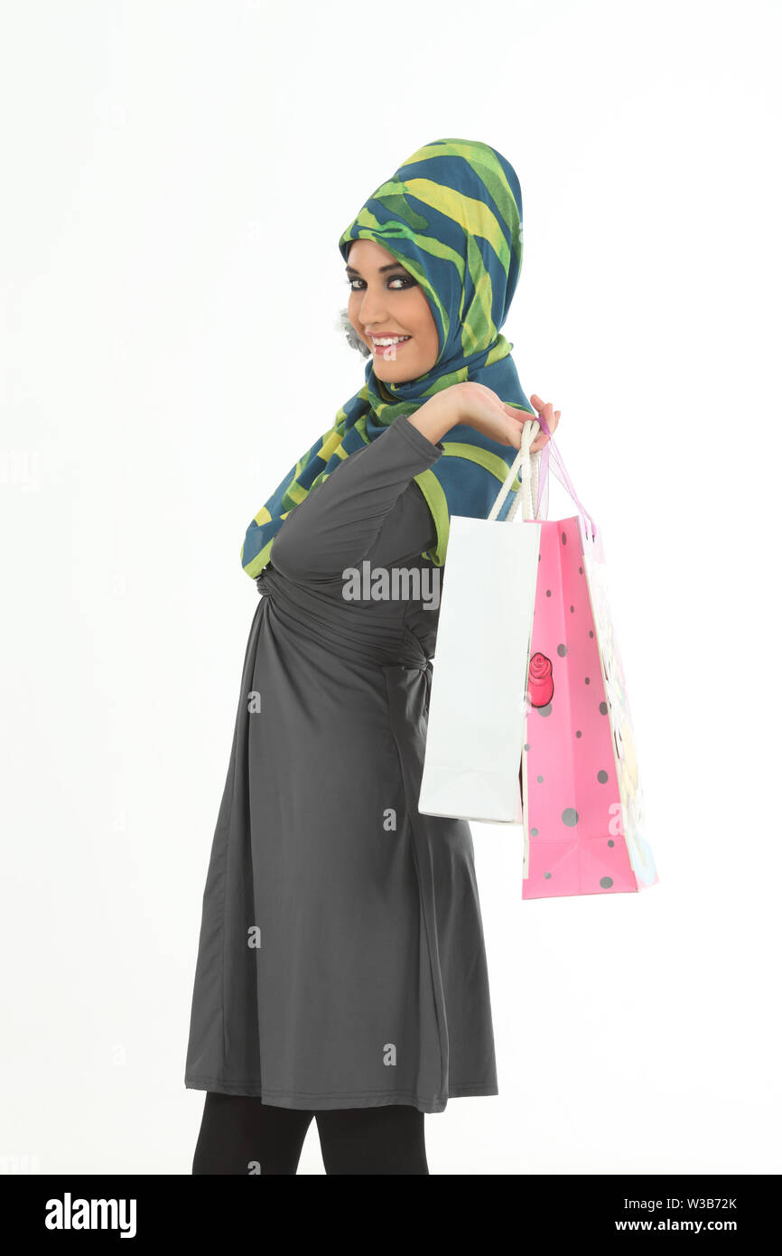 Woman carrying shopping bags and smiling Stock Photo
