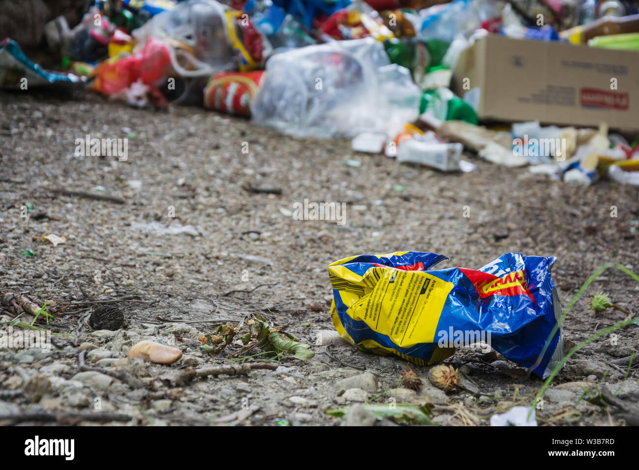 Thrown plastic bag and a bunch of garbage in the background