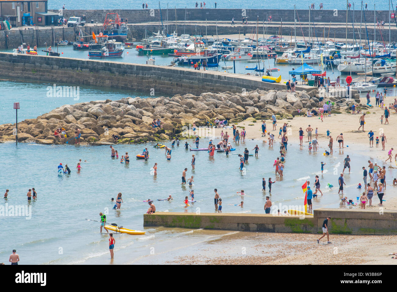 Lyme Regis, Dorset, UK. 14th July 2019. UK Weather Crowds of
