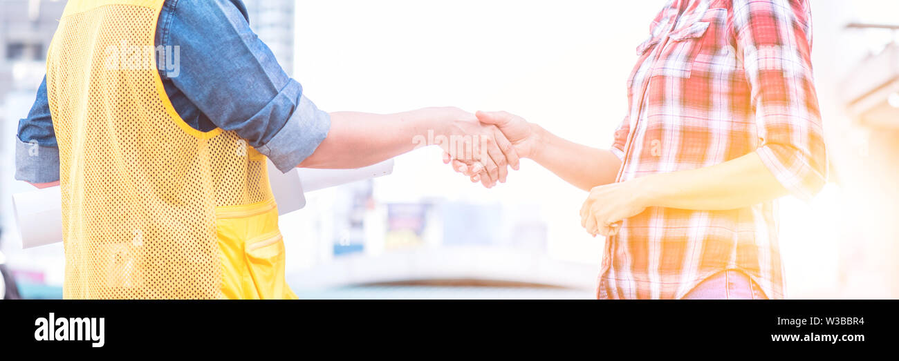 engineer handshake with worker, project building construction and real ...