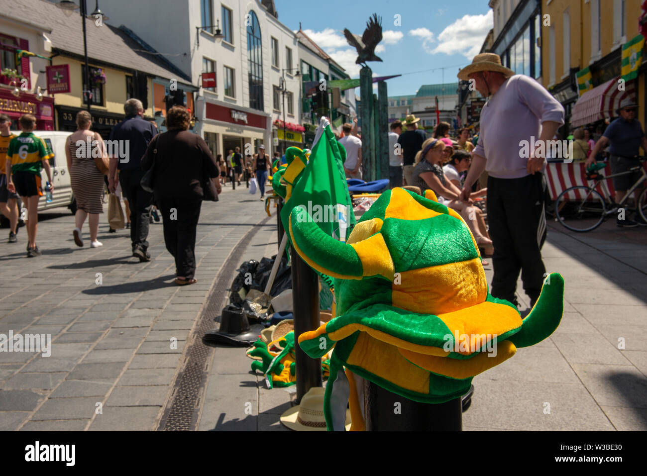 Match day in Killarney, County Kerry, Ireland. Street vendor selling Kerry Gaelic football memorabilia on Main Street before the Mayo and Kerry game in July 2019. Stock Photo