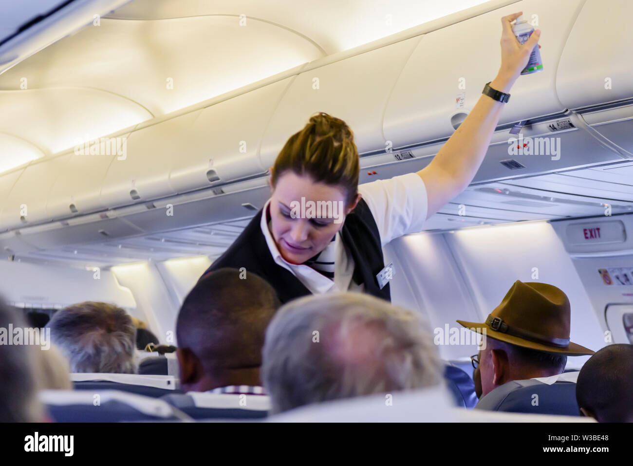 British Airways (operated by Comair) cabin crew sprays an insecticide inside the cabin before take-off as a precaution.  Namibia Stock Photo