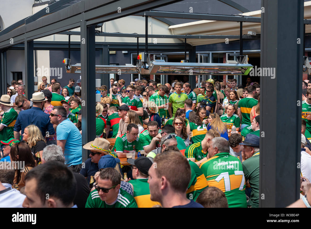 Kerry Gaelic football fans supporters at the Scott's Hotel open air bar pub garden during the Mayo and Kerry game in July 2019. Killarney, County Kerry, Ireland Stock Photo