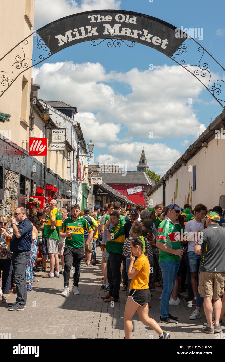 Kerry and Mayo Gaelic football fans supporters on a match day in the Killarney streets  at the Old Milk Market lane before the Mayo and Kerry game in July 2019 on matchday in Killarney, County Kerry, Ireland Stock Photo