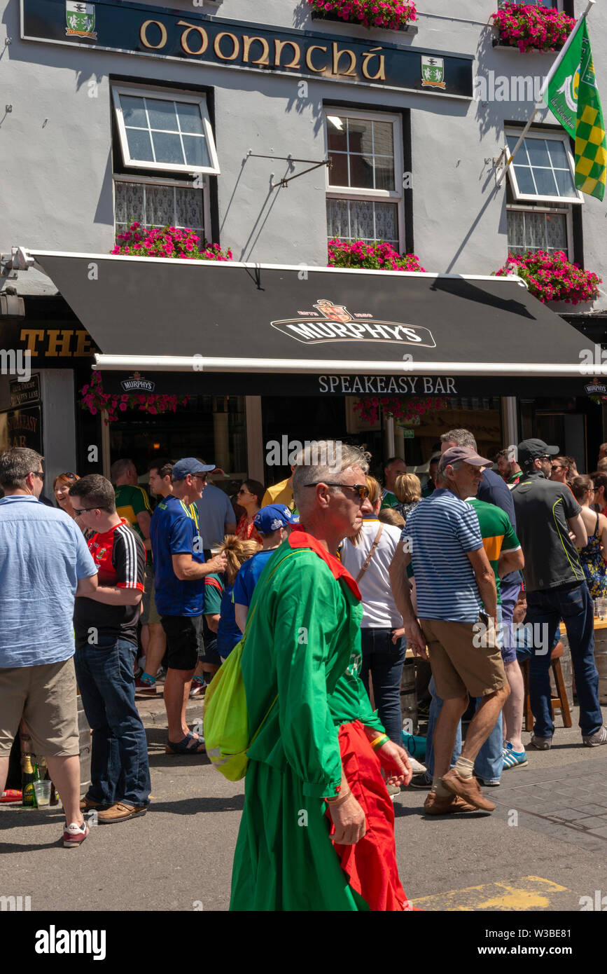Match day in Killarney, County Kerry, Ireland. Gaelic football fans supporters outside Speakeasy Bar on the Killarney streets before the Mayo and Kerry game in July 2019 Stock Photo