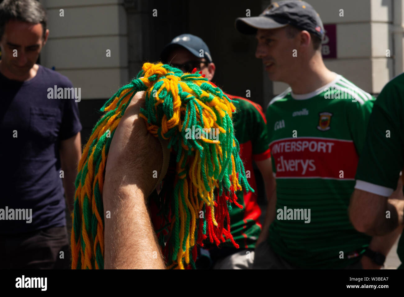 Mayo supporters and a hand holding Kerry Football team colours memorabilia  on a match day in Killarney, County Kerry, Ireland Stock Photo - Alamy