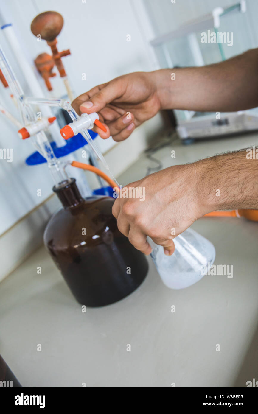 Man or male hold test tube in hands produces chemistry experiment test