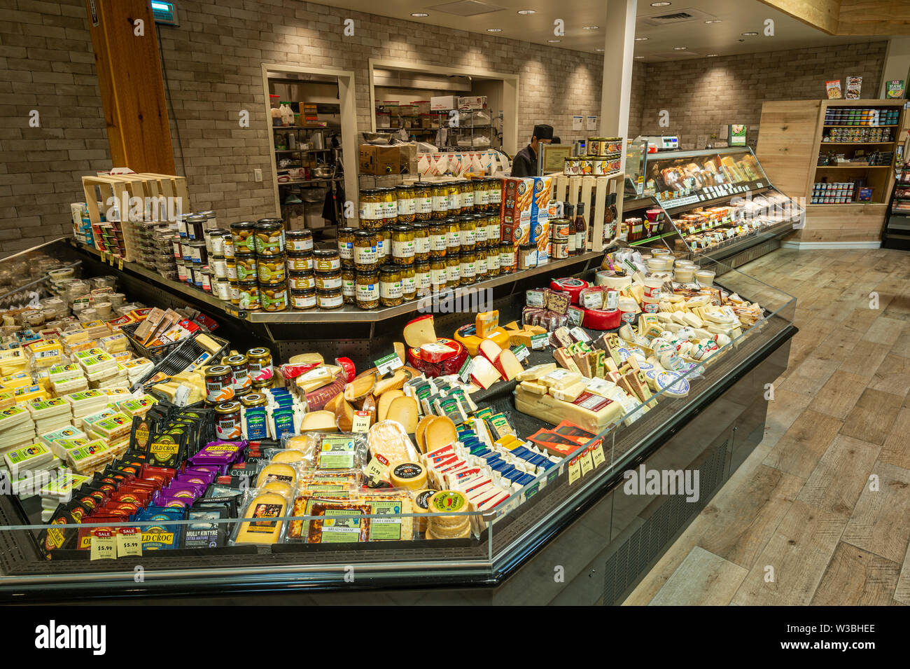 Large Cheese Display In American Grocery Store Stock Photo