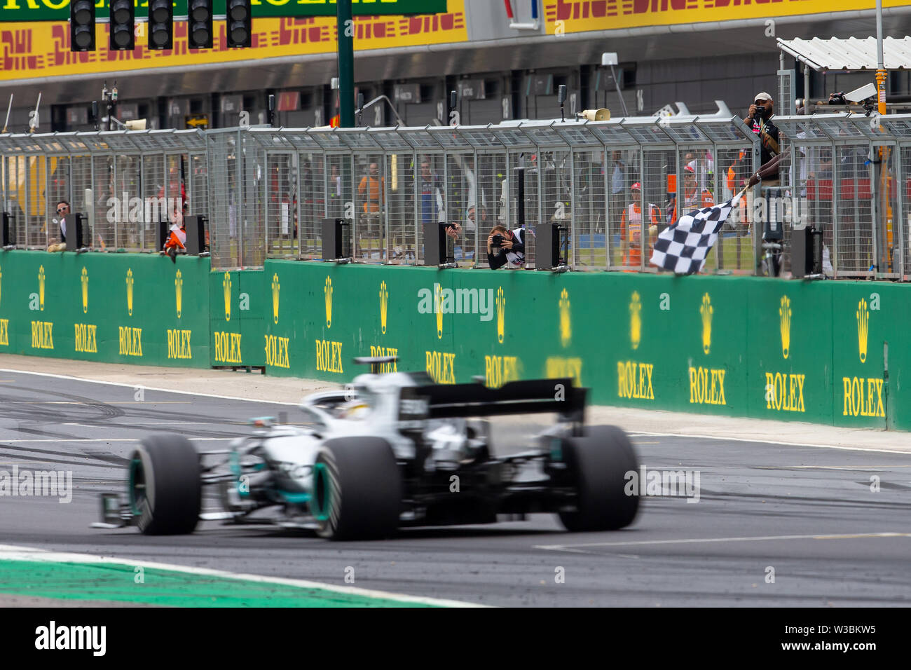 Silverstone, UK. 14th July 2019. FIA F1 Grand Prix of Britain, Race Day;  Lewis Hamilton driving his Mercedes AMG Petronas Motorsport F1 W10 takes  the chequered flag to win the Grand Prix