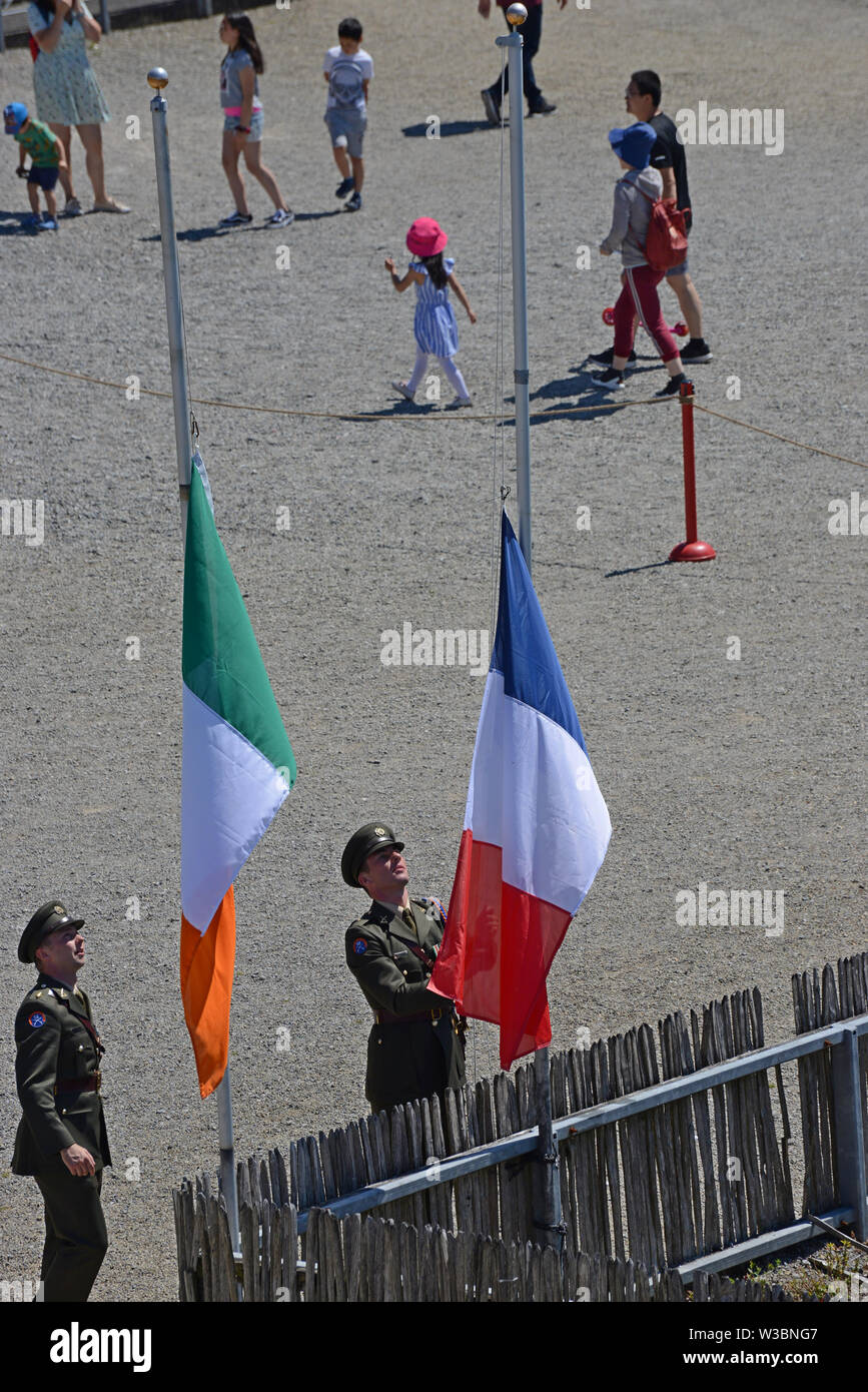 Limerick, Ireland. 14th July 2019. Limerick celebrates Bastille day with the official launch of the Wild Geese Festival with a parade and flag raising at King John's Castle.  Members of the Irish Defence Forces prepare the flags for raising. Credit: G.P.Essex/Alamy Live News Stock Photo