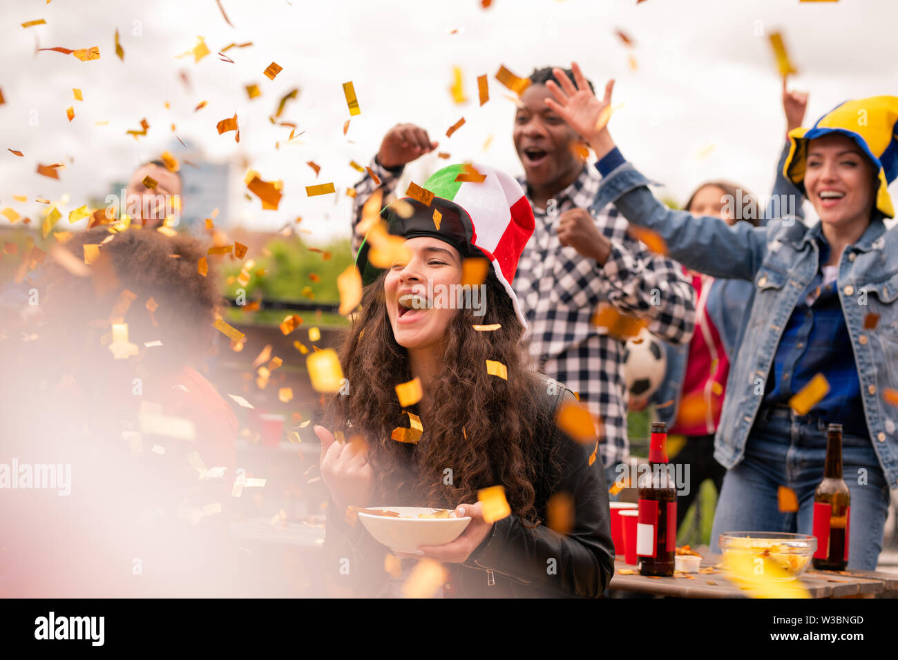 Joyful multicultural girls and guy expressing joy while shouting ecstatically Stock Photo