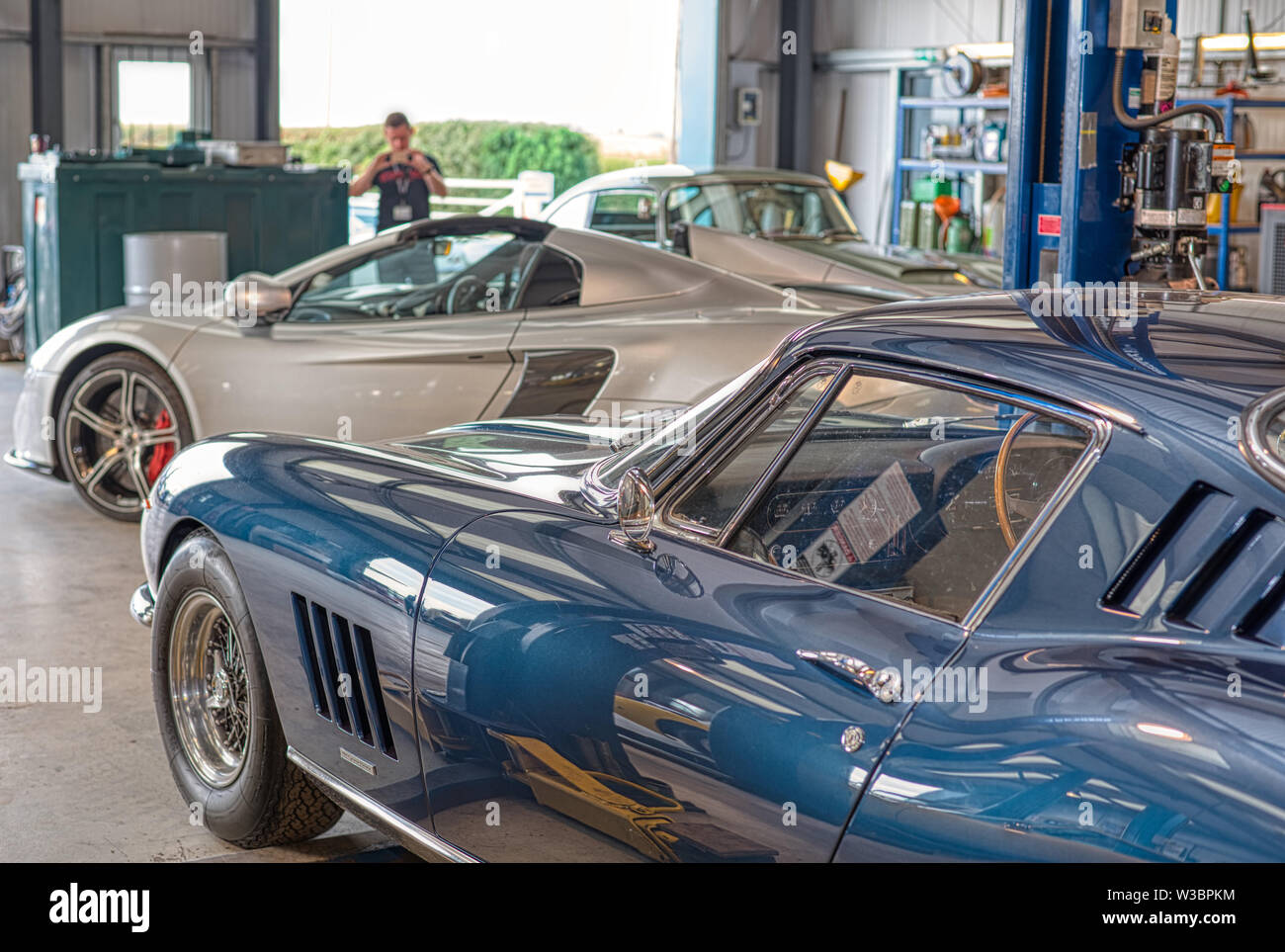 Ferrari and McLaren in classic workshop at Autofest, Winchester Auto Barn, Sutton Scotney, Hampshire, UK Stock Photo