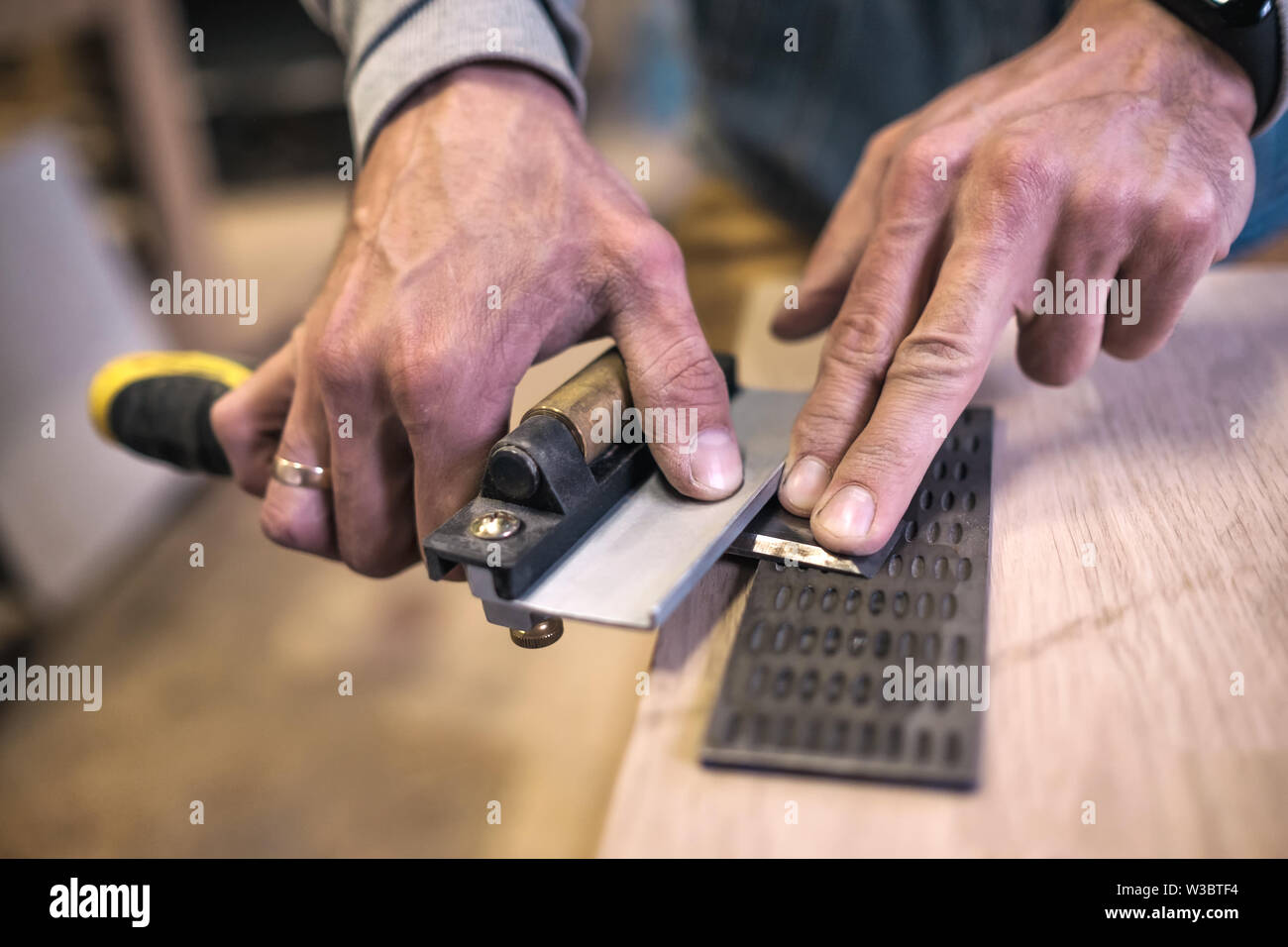Close up worker sharpening chisel hi-res stock photography and images ...