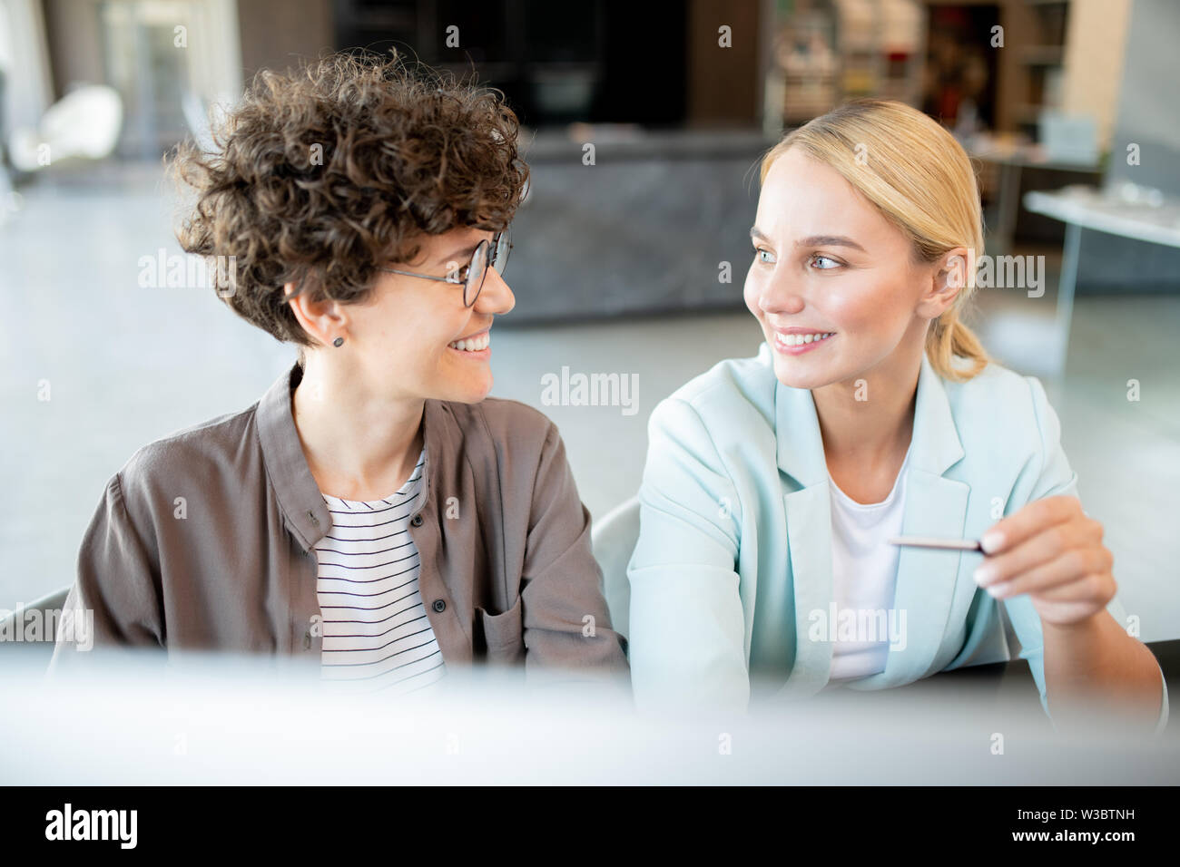 Two young successful managers discussing new ideas Stock Photo