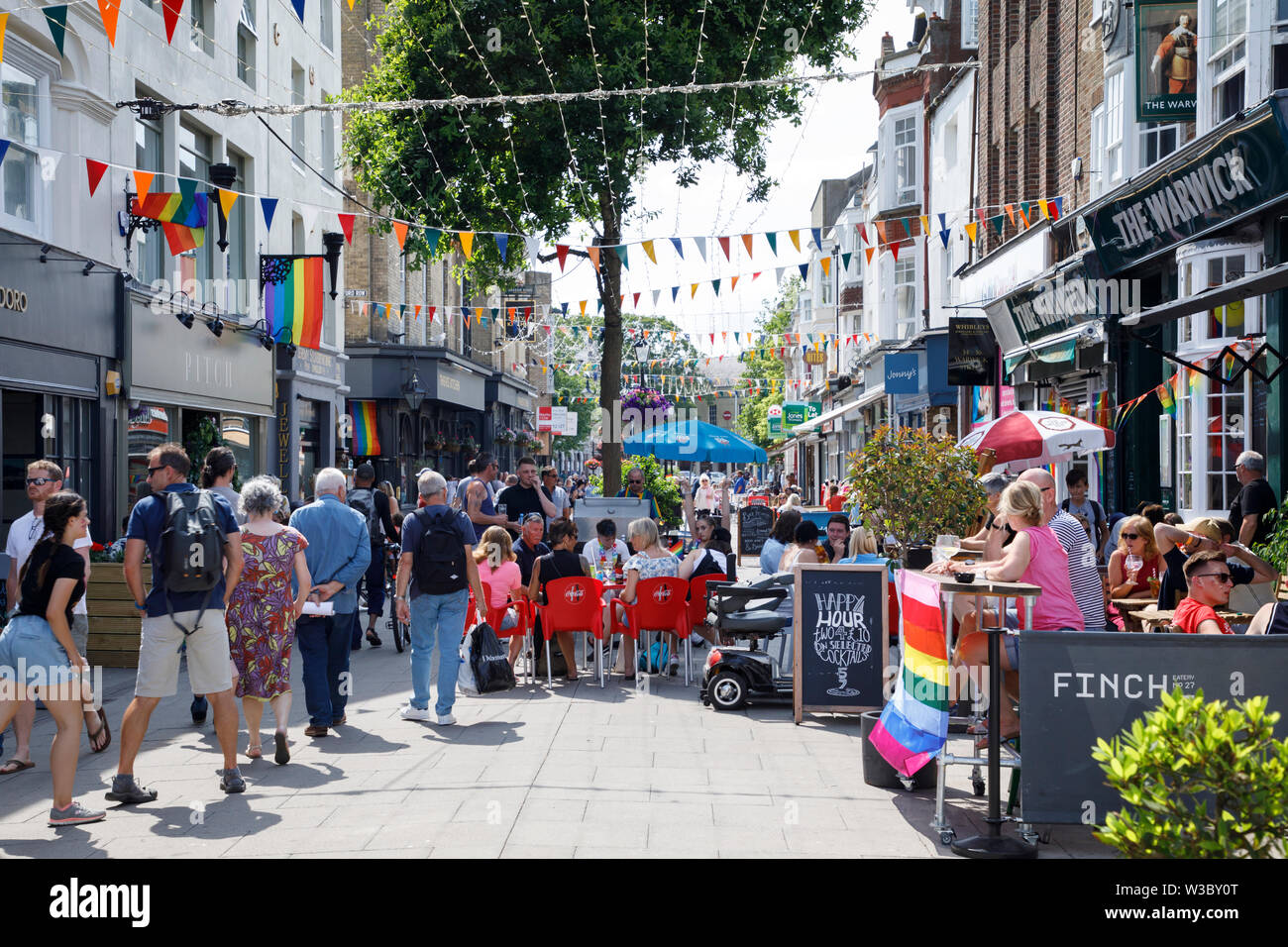 WORTHING, UK - JULY 13, 2019: People enjoying day out in the town decorated for Gay Pride Parade Stock Photo