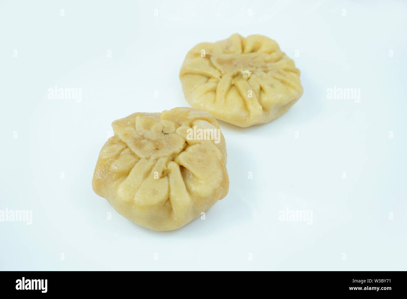 Oriental wheat all purpose flour stuffed Dumplings isolated on white background Stock Photo