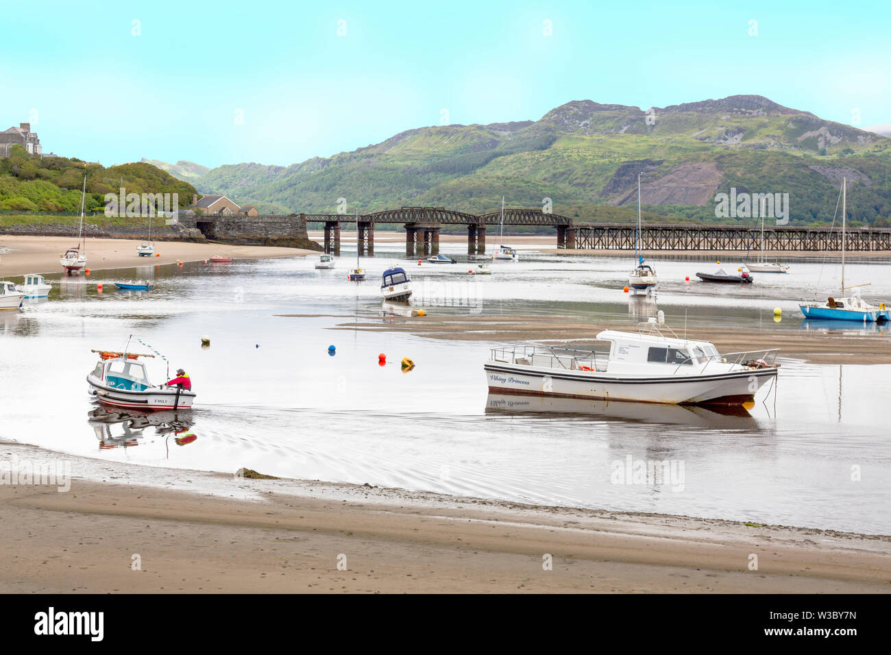 The historic railway bridge across the Mawddach estuary viewed from the harbour in Barmouth, Gwynedd, Wales, UK Stock Photo