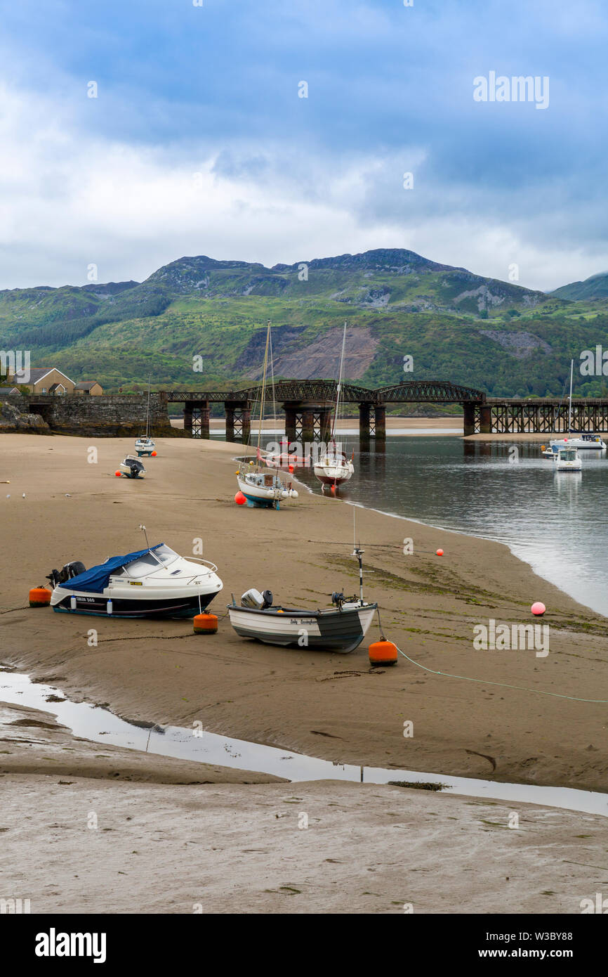 The historic railway bridge across the Mawddach estuary viewed from the harbour in Barmouth, Gwynedd, Wales, UK Stock Photo
