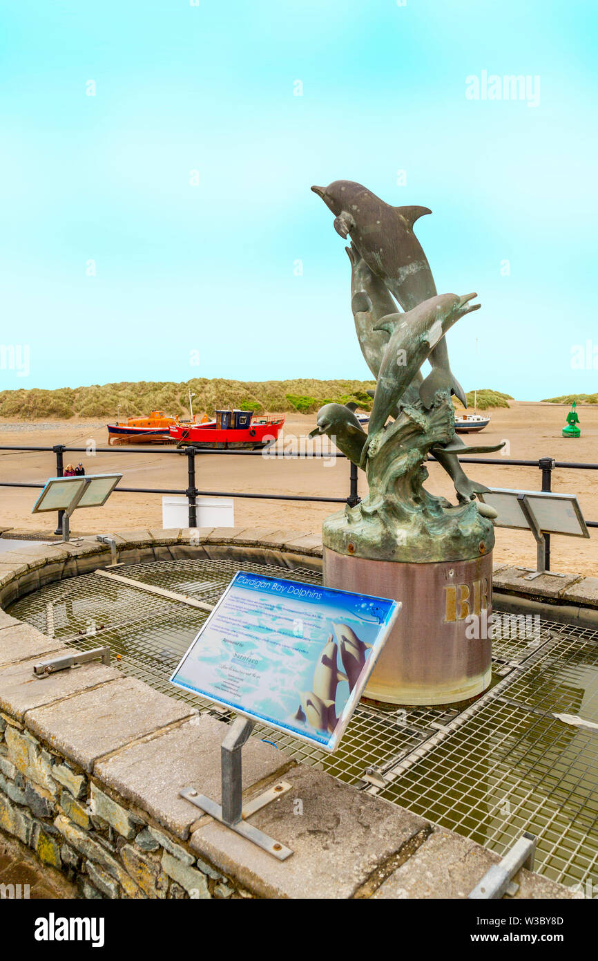 Statue of Cardigan Bay dolphins on the quayside in Barmouth, Gwynedd, Wales, UK Stock Photo