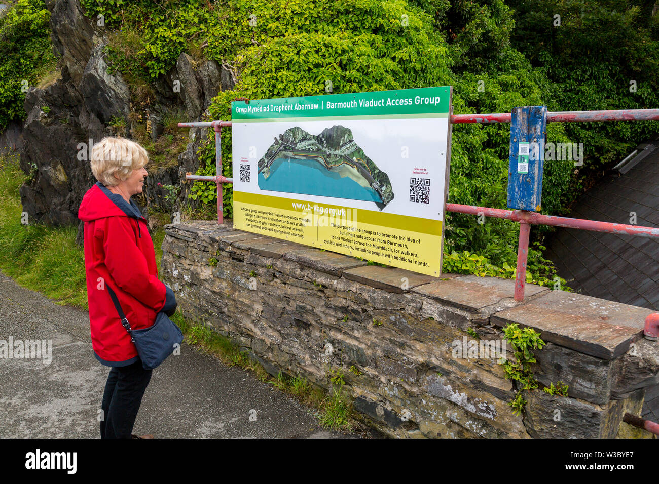 Information board about the historic railway bridge across the Mawddach estuary viewed from the harbour in Barmouth, Gwynedd, Wales, UK Stock Photo