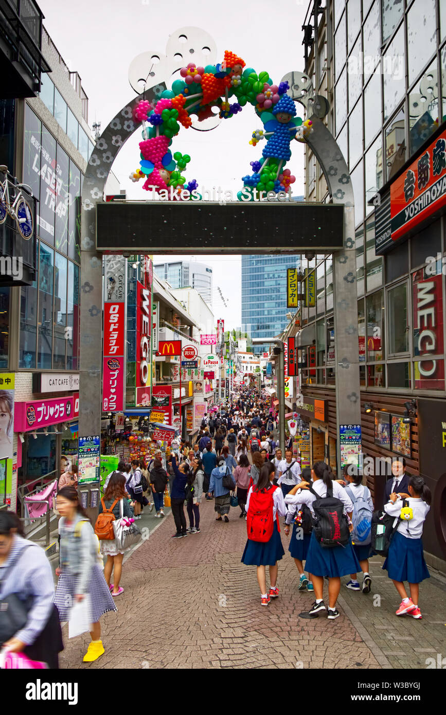 Young people walk down Takeshita-dori, in the Harajuku district of Tokyo, Japan looking for teen fashion and other bargains Stock Photo