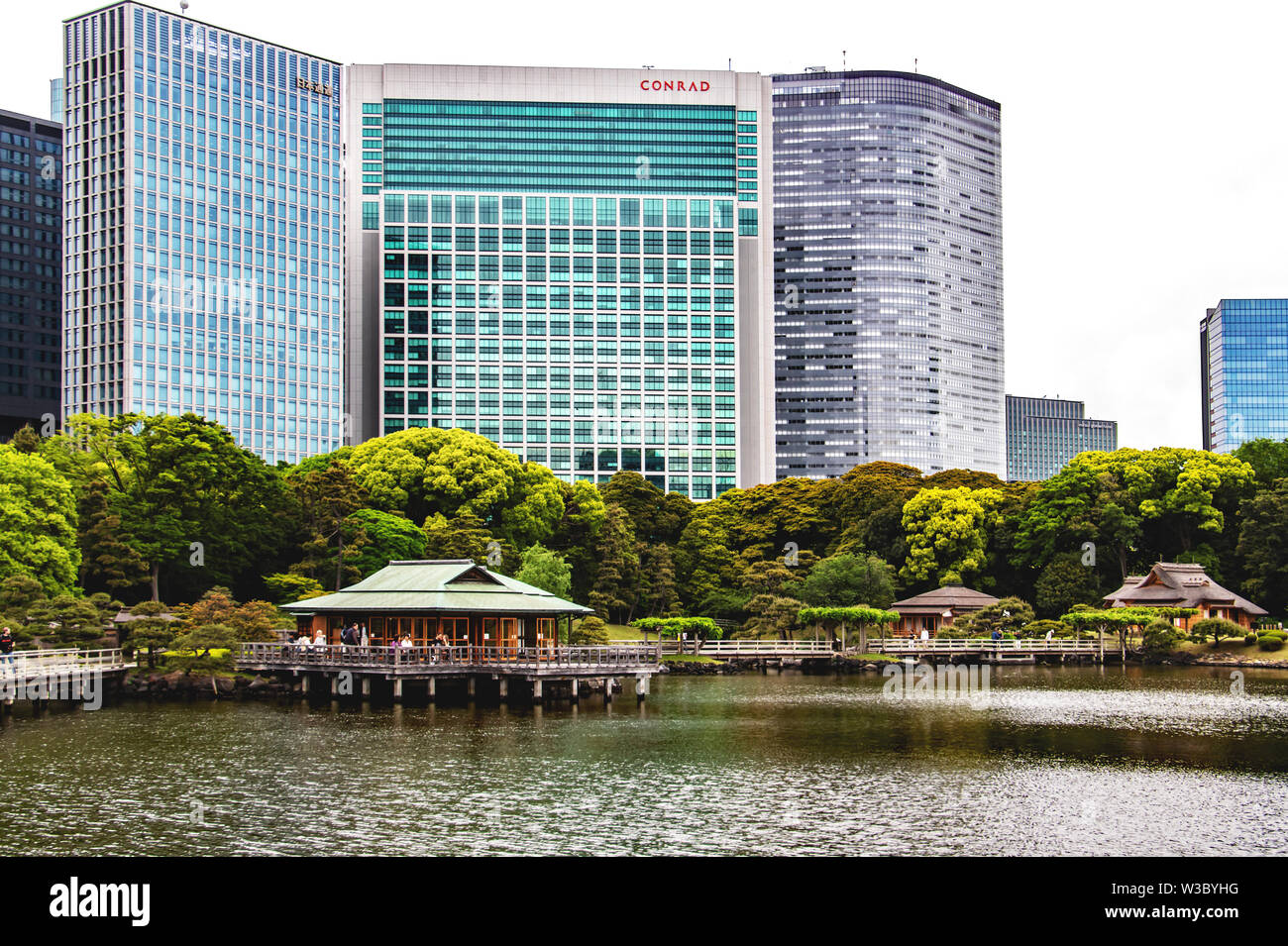 An ochaya or teahouse in Hamarikyu Gardens, Tokyo, Japan is dwarfed by the skyscraper buildings behind it Stock Photo