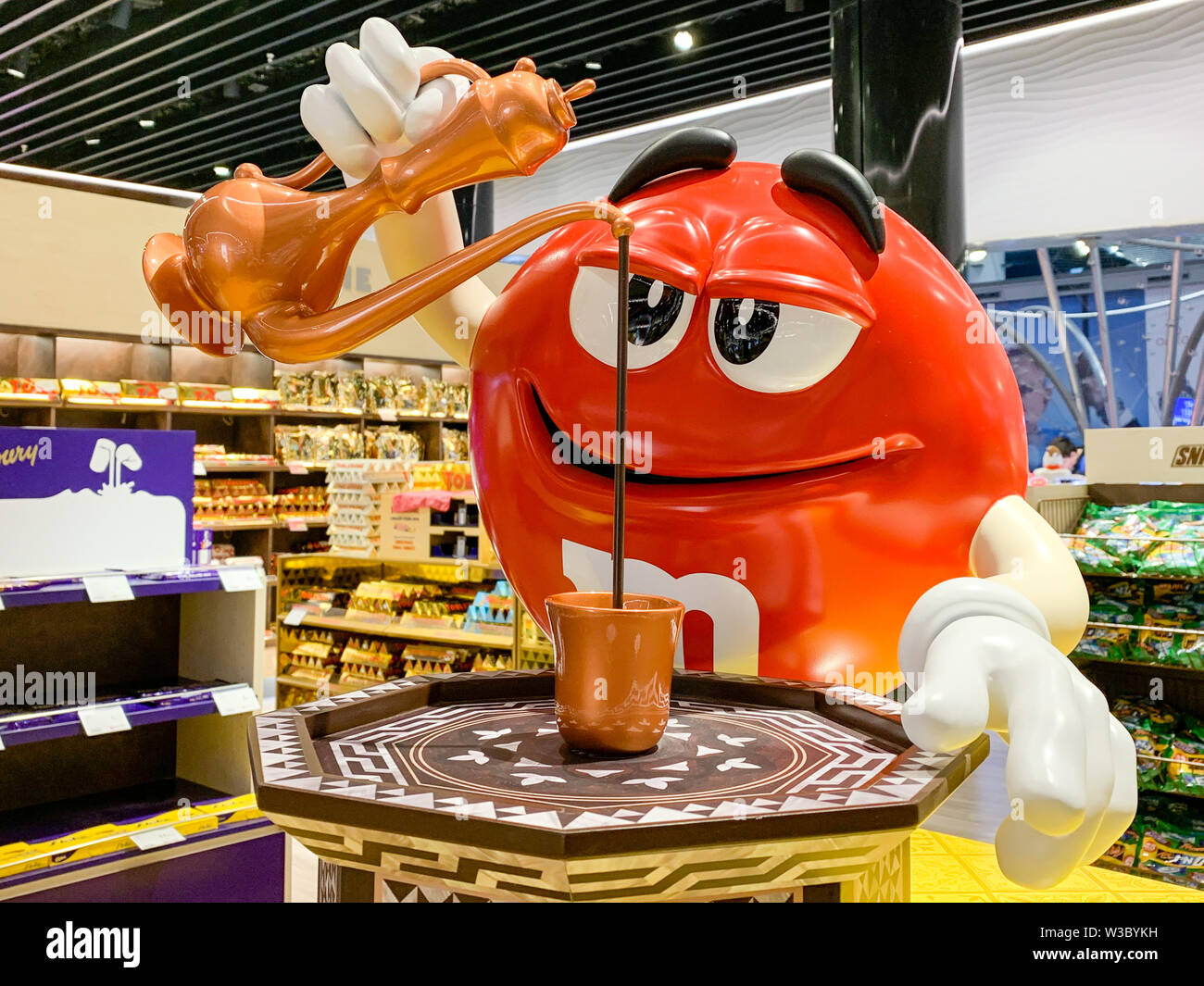 M&M mascot figure pouring Turkish coffee in a mug. Adaption of candy advertising of the company MARS for different regions and countries. Istanbul, Tu Stock Photo