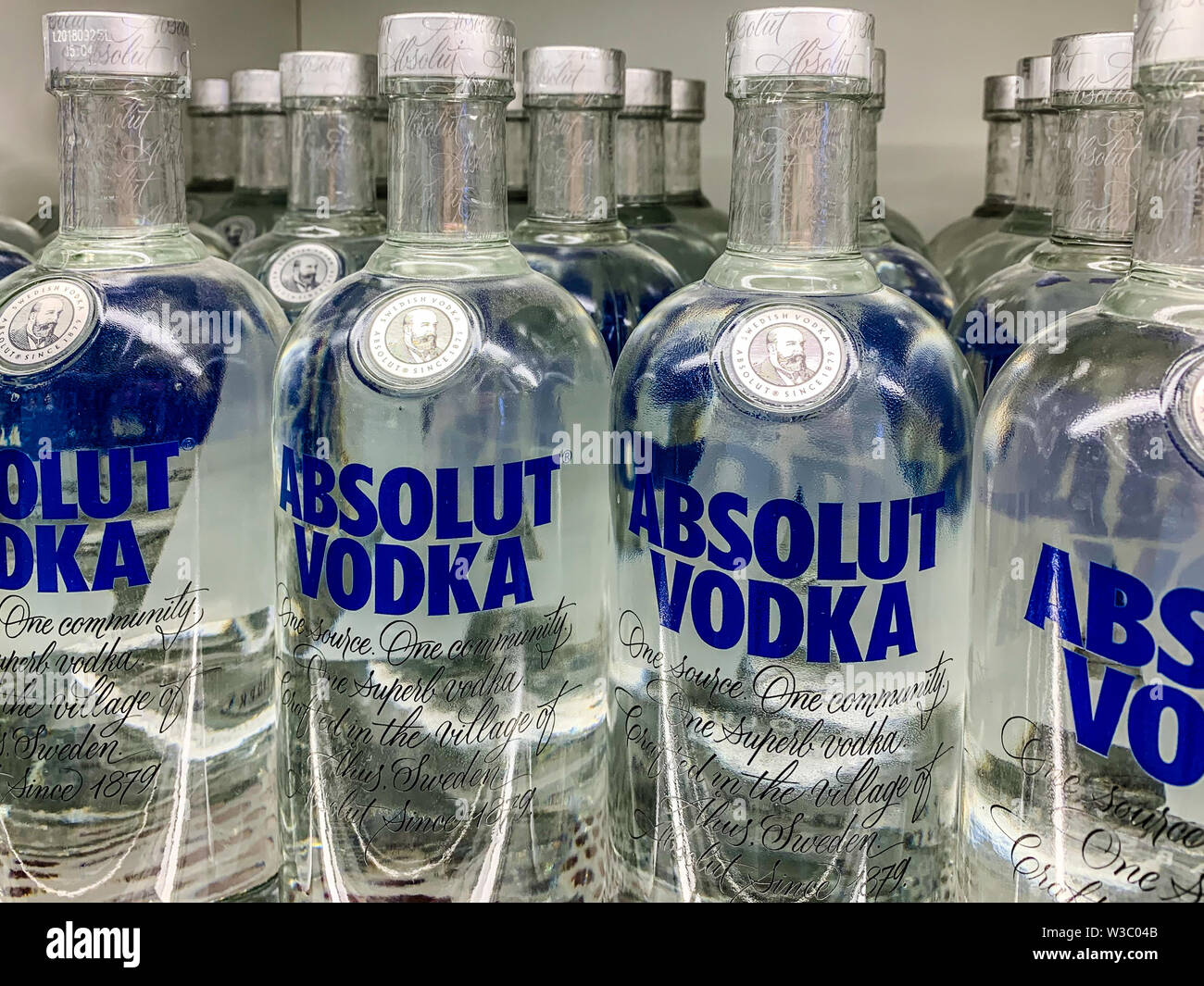 Vodka bottles on a shelf in a store. Absolut Vodka is a famous brand of vodka, produced near Ahus, in southern Sweden, owned by the French group Perno Stock Photo