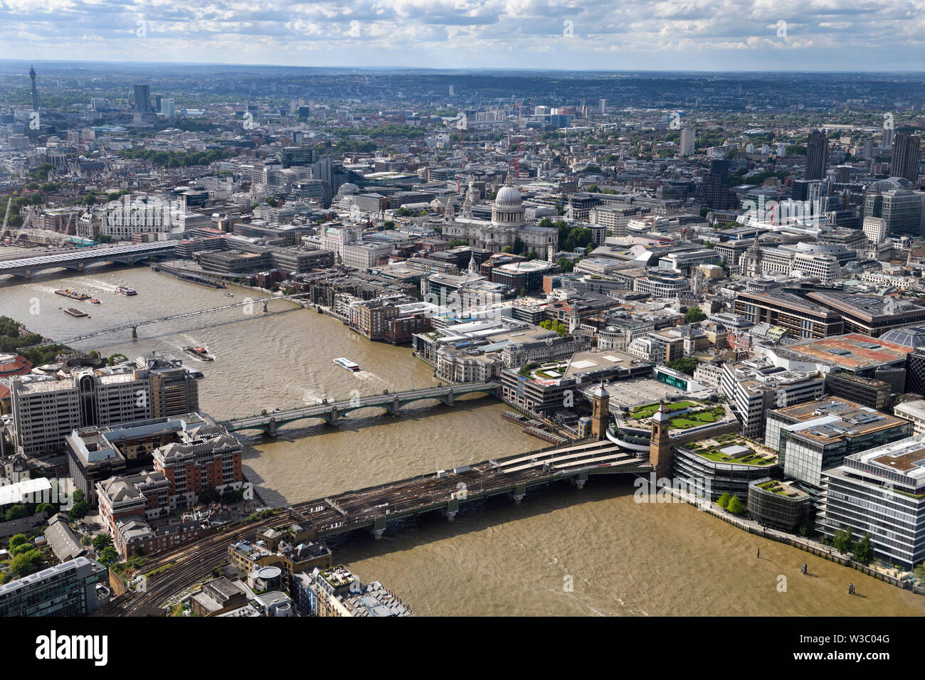 Aerial view of London England with BT Tower and bridges over the muddy River Thames and St Paul's Cathedral Anglican church Stock Photo