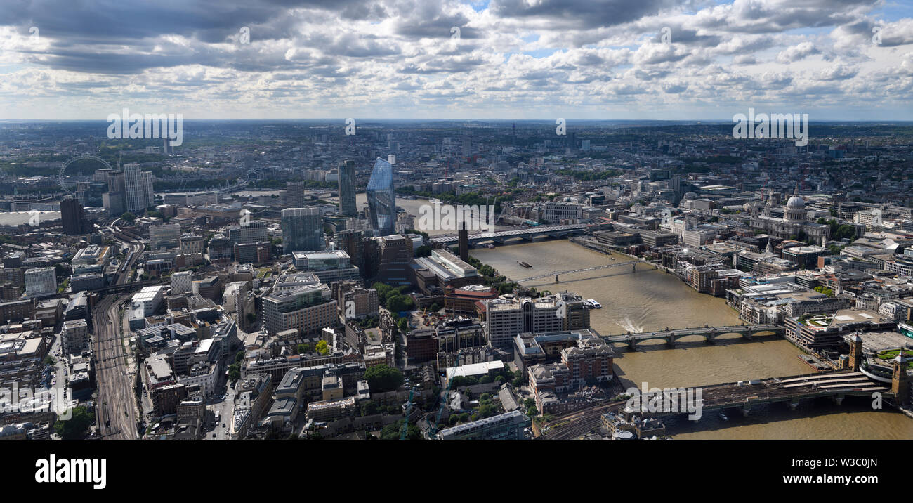 Aerial panorama of South London England with London Eye, train tracks The Vase and bridges over the muddy River Thames and St Paul's Cathedral Stock Photo