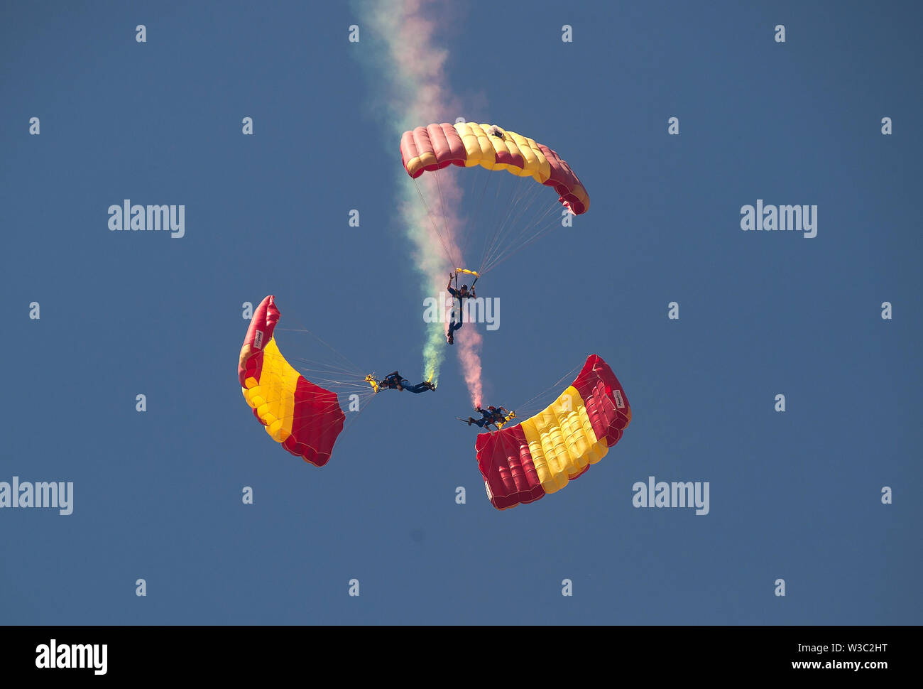 Spanish paratroopers perform in the air during the Festival.The 2019 International Torre del Mar Airshow Festival is being hosted on 12,13 and 14 of July this year, attracting over 300,000 spectators. Members of different patrols perform with exhibitions and acrobatics during the festival. Stock Photo