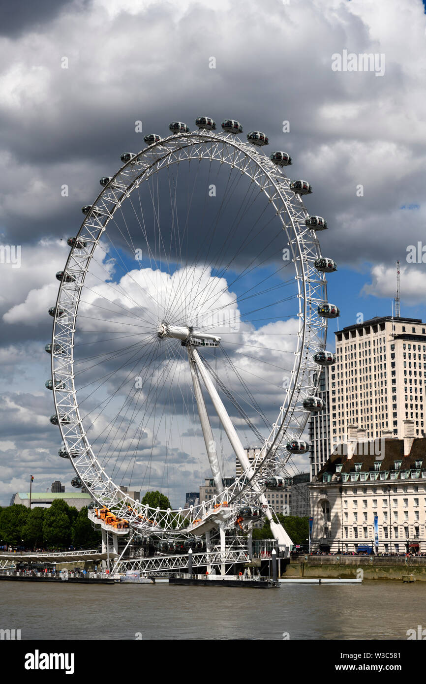 London Eye on the River Thames with tourists lined up for the tallest cantilevered observation wheel ride London England Stock Photo