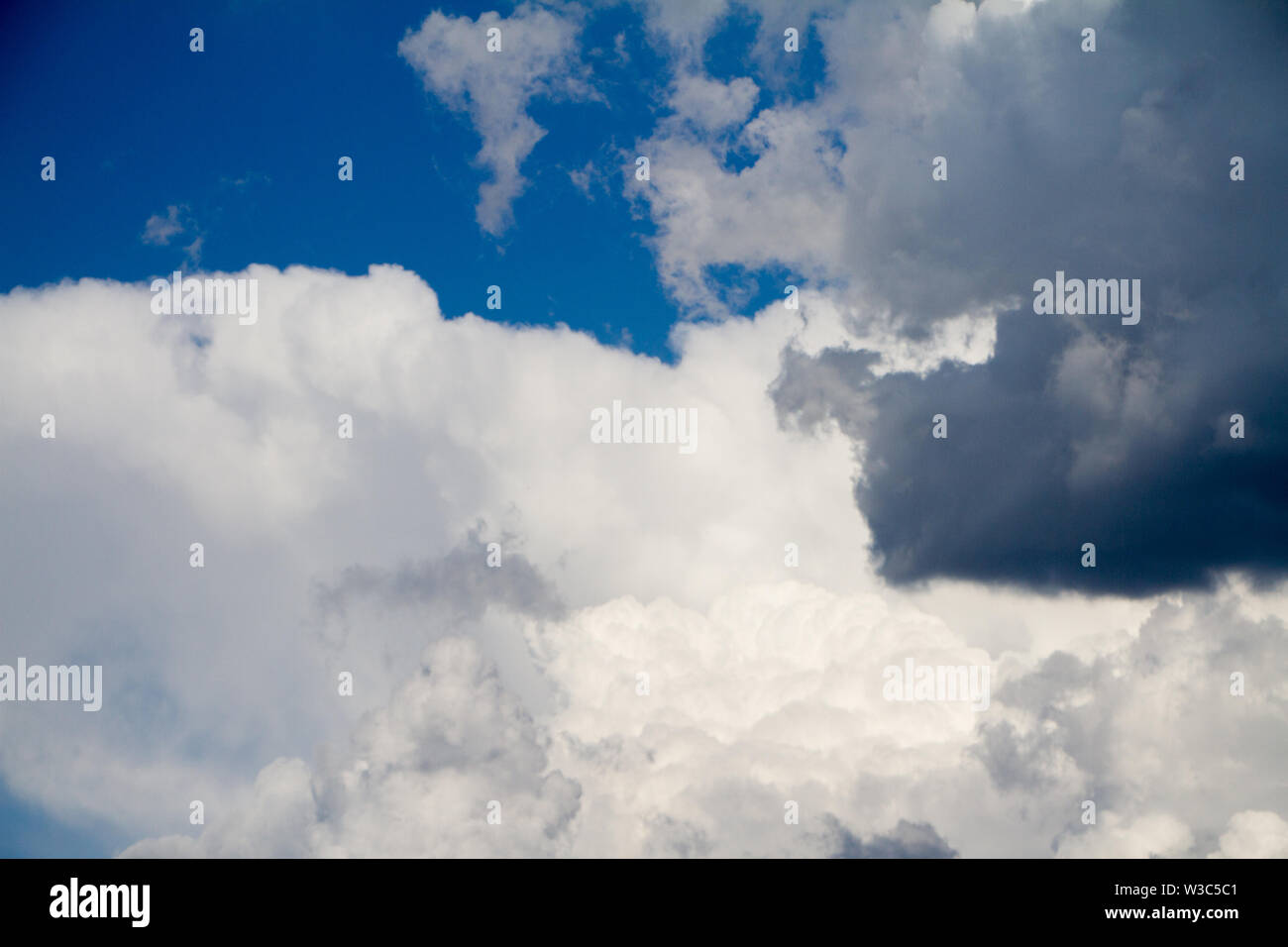 A landscape with blue sky and white cumulus clouds, background or ...