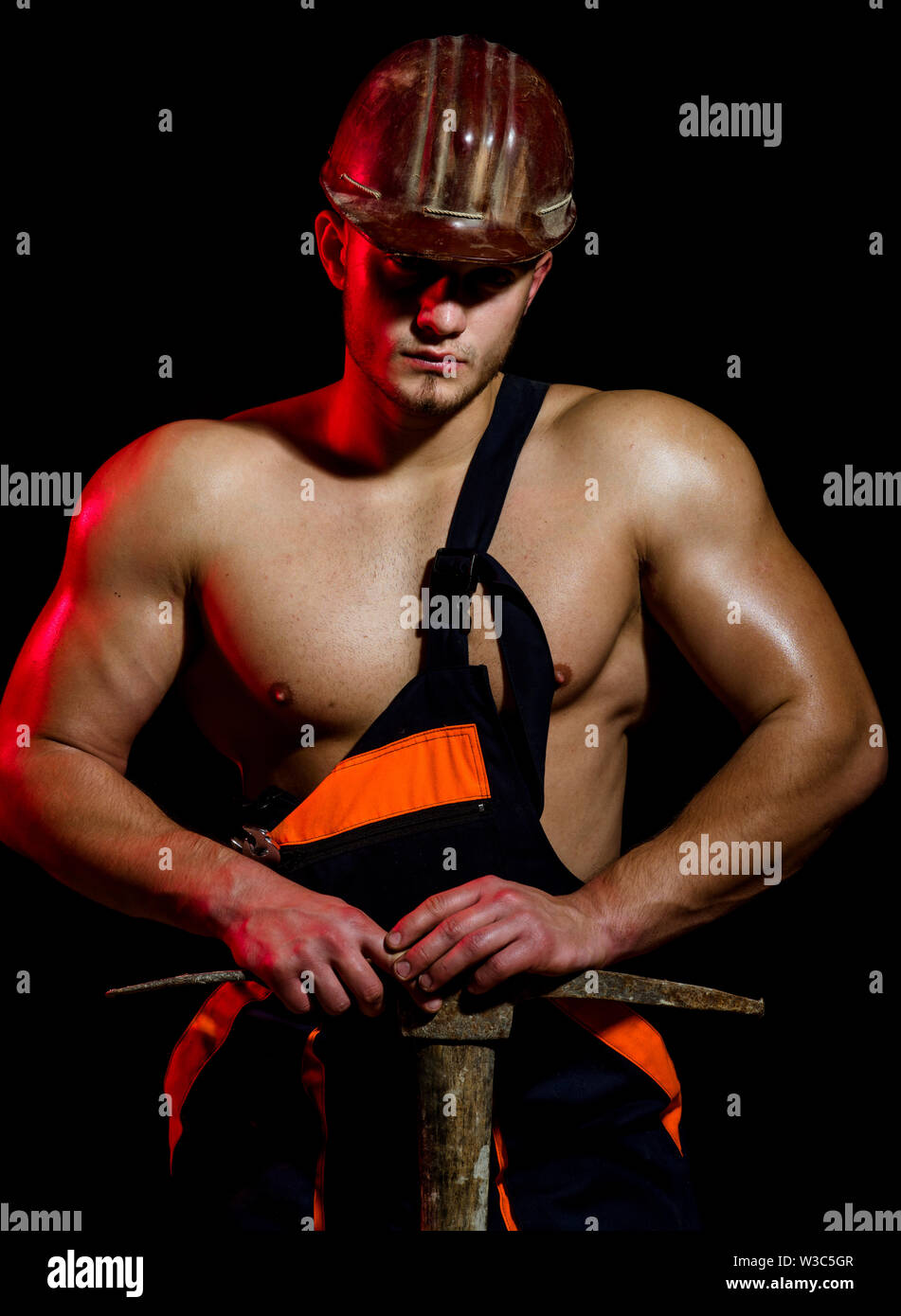 Under construction, we are closed for refurbishment. Muscular man ...