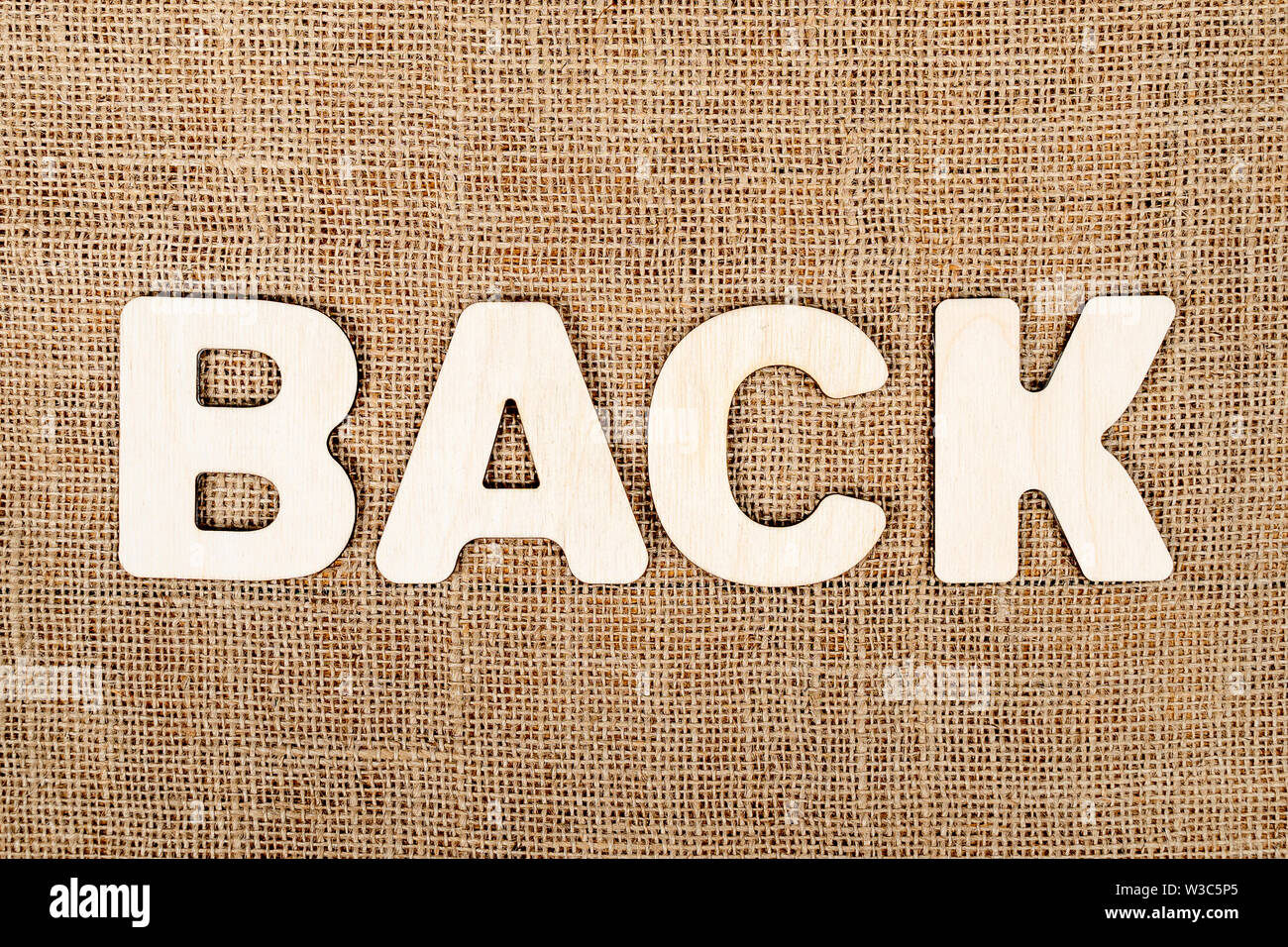 word back is laid out in wooden letters on the old brown canvas Stock Photo Alamy