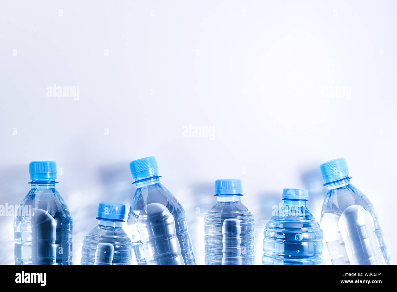 Several plastic water bottles on white background Stock Photo